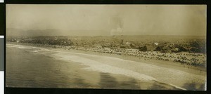 View of a crowd on a beach in Long Beach watching Pacific Fleet maneuvers, 1908