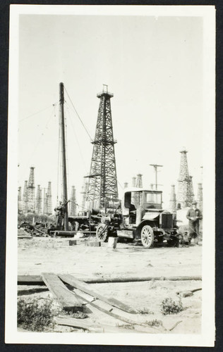 An oil worker removing the casing from an abandoned oil well