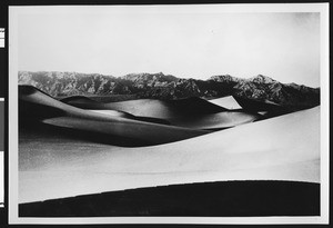 Panoramic view of sand dunes and mountains