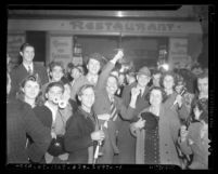 People on Broadway Street celebrating New Year's Eve, 1940 Los Angeles, Calif