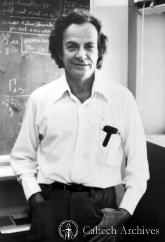 Richard Feynman, casual pose before blackboard