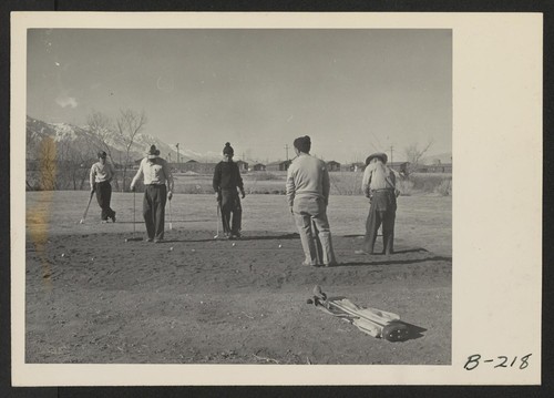 Golfing enthusiasts enjoy a friendly game of golf at Manzanar Golf Course. These golfers, and other fellow evacuees, when clearing