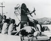 Tam High School students in with model of clock tower in parade, circa 1968