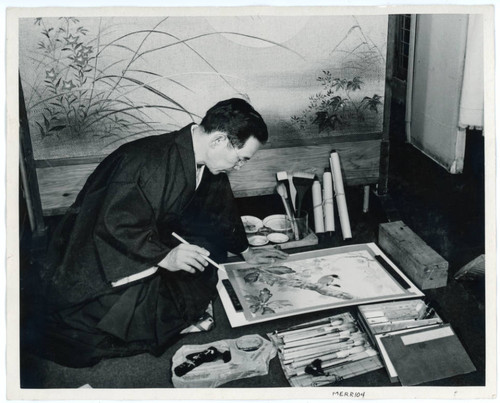 Photograph of Kango Takamura working on a painting