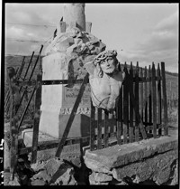 [Miscellaneous: broken Christ sculpture hung on the railing of a damaged memorial, [Small house with bomb damage, Ammerschwihr?]