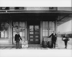 Two men and a boy with barrels of beer outside the Union Beer Hall and John Hermer's pool hall, Petaluma, California(?), about 1895