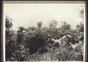 A Djale village. They place inverted pots on the tops of their roofs to prevent rain getting in. To get to Djale you have to cross high mountains (1928)