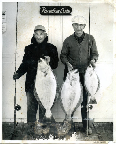 Two fishermen with their catch at Paradise Cove