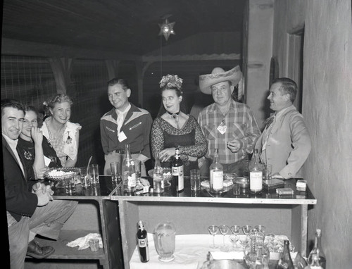 Guests gathered around a bar at Miss McKanna's Halloween Party
