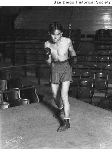 Boxer Johnny Lee posing in a boxing ring