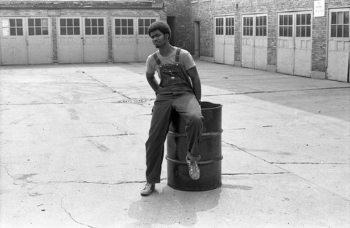 Man leaning on drum, Chicago, 1971