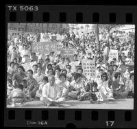 Crowd with signs in Korean and English at rally in support of protesters in South Korea, Los Angeles, 1987