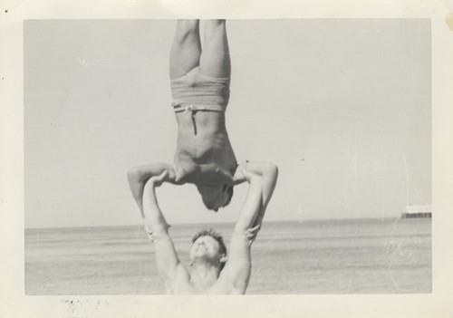 Harry Murray holding Lloyd Hooper in a handstand at Cowell Beach