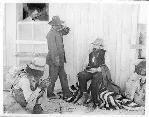 George Wharton James takes notes as a Walapai Indian man demonstrates how to make fire, Kingman, Arizona, ca.1902