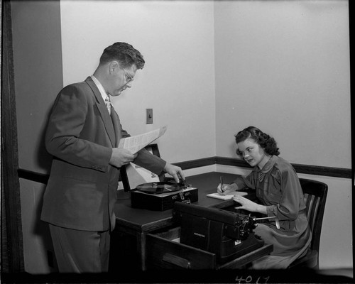 Young lady taking a dictation test from a phonograph record at SCE
