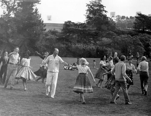 [People dancing on a field during the Golden Gate Park Centennial Parade]