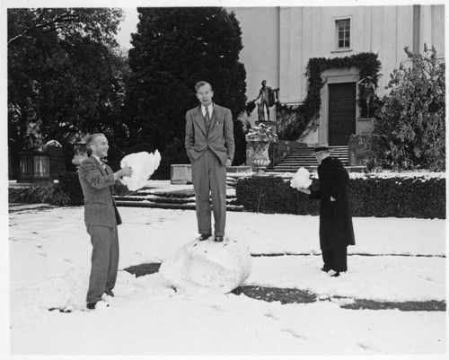 Graydon Spalding, Carey Bliss, and John Moslander play in the snow on the lawn south of the library building, January 11, 1949