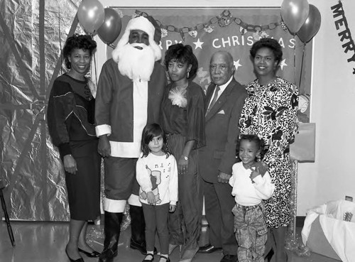Children's Collective guest Gilbert Lindsay and other posing with Santa, Los Angeles, 1987