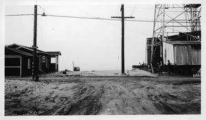 Looking west on 37th Avenue from point 100 feet west of Speedway showing sand on surface of Speedway, Los Angeles County, 1940