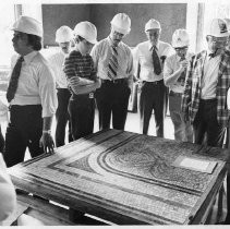 The men who work at the California State Capitol take a tour of the progress being made on the restoration project. Here they examine a mosaic