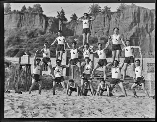 Acrobats pose in human pyramid, Gables Beach Club, Santa Monica