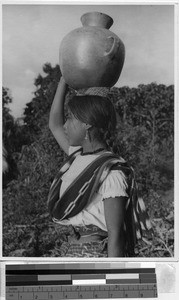 Portrait of a girl carrying a water jug on her head, Guatemala, ca. 1946