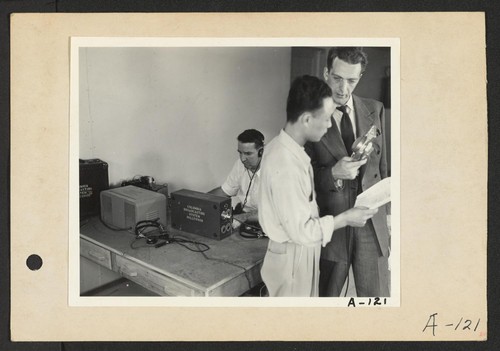Poston, Ariz.--Kay Nishimura, evacuee of Japanese ancestry, and Chet Huntley (right), CBS announcer, in an interview at this War Relocation Authority center during a nationwide hookup. Photographer: Clark, Fred Poston, Arizona