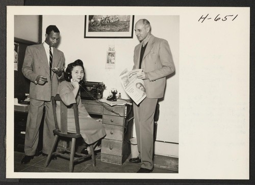 Mary Kito, Nisei from Granada, and office manager of Now magazine, is shown here with public relations man Foster Ricardo