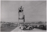 [Exterior general view of construction forklift, Newberry Electric Corporation, on bridge] (3 views)