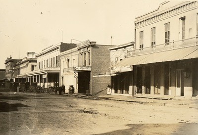 Stockton - Streets - circa 1880s: Center St. looking north from Market St. Chung Hop Laundry, J.H. Andrews Harness