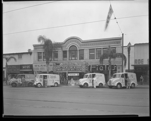 Strand Theater exterior with milk trucks 1945
