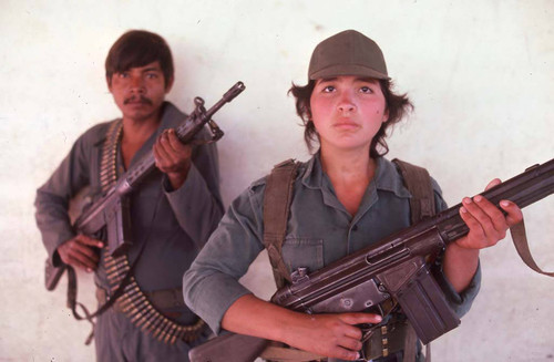 Guerrilleros with rifles standing in front of white wall, La Palma, 1983
