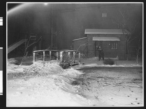 Unidentified film being made in a studio made to look like a snowed-in cabin, ca.1940