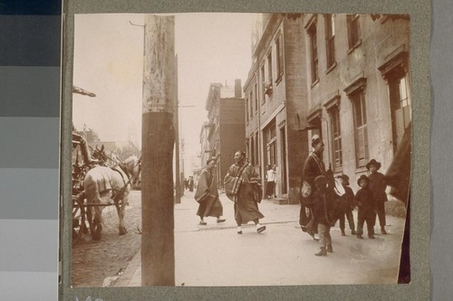 [Street scene with Chinese priests.]