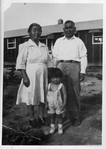 Tsukamoto family in front of barracks at Jerome Relocation Center