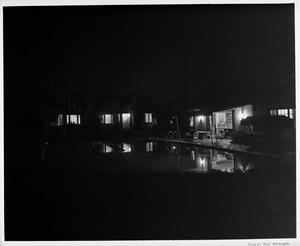 Residential home swimming pool at night, private gardens of 1948, Palm Springs