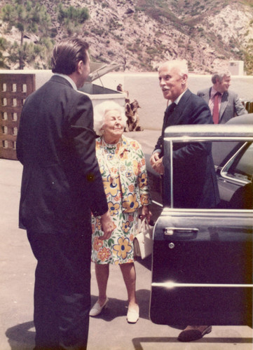 Mrs. Robinson arriving at the Brock House, Dean Hudson in the background