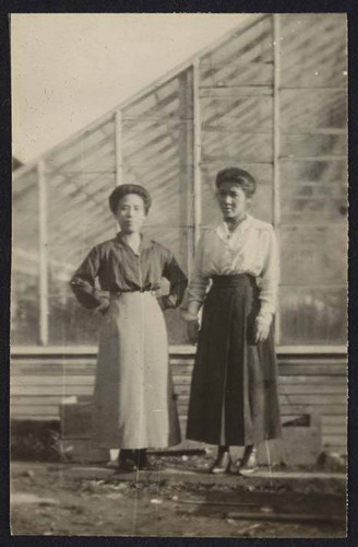 Women in front of a greenhouse