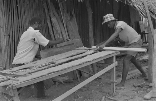 Two men working at a construction table, San Basilio de Palenque, 1977