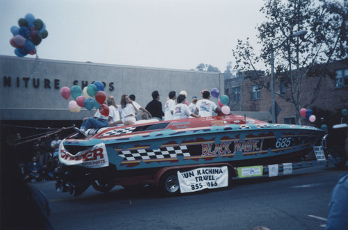 KLOS Radio's Mark and Brian "Day Before Thanksgiving" Parade with "Black Magik" boat float being towed down South Glassell Street, Orange, California, 1995