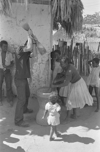 Richard Cross and woman grinding corn, San Basilio de Palenque, ca. 1978