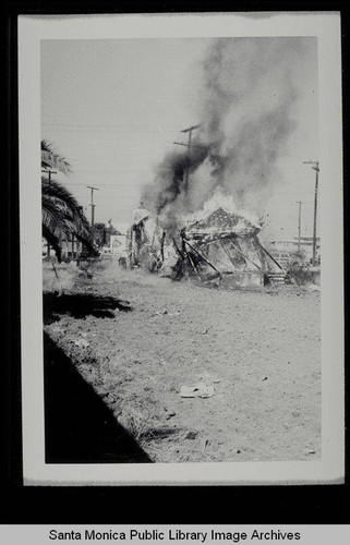 Burning a derelict house on Belmar Place between Main and Third Streets, north of Pico, on July 1, 1953