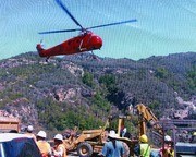 People and helicopter at work for the Topanga Creek Wrecked Car Removal Project, Topanga, California