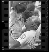 Dodger's manager Tommy Lasorda playing with shortstop, Dave Anderson's daughter, Christa, 1985