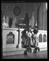 Two girls praying at alter of Daughters of Charity orphanage in Los Angeles, Calif., 1950