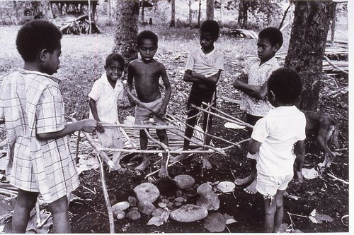 Children at play building a cooking house