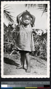 Girl in a striped dress, Cameroon, ca.1920-1940