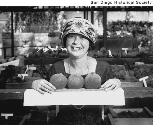 Thelma Davis posing with fruit at a county fair