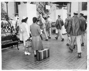 "Dramatic Meeting--As the returned Japs chatted gayly at Union Station, a group of Marines (who had seen action tin the Pacific theater) filed past"--caption on photograph