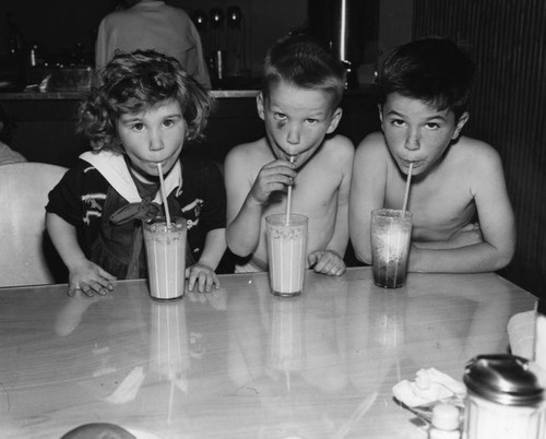 Children sipping drinks